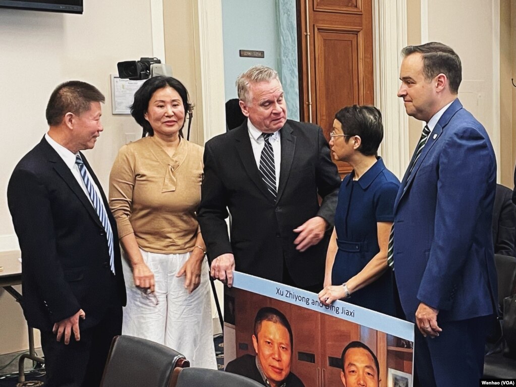 中国被捕入狱律师的妻子罗胜春（中右）与耿和（中左）与美国国会议员克里斯·史密斯（中）合影（2023年4月20日）(photo:VOA)