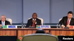 FILE - Brazil's President Michel Temer, South Africa's President Cyril Ramaphosa and China's President Xi Jinping attend the BRICS summit meeting in Johannesburg, South Africa, July 27, 2018. 