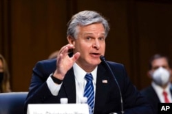 FILE - FBI Director Christopher Wray testifies during a Senate Judiciary hearing about the Inspector General's report on the FBI's handling of the Larry Nassar investigation on Capitol Hill, Sept. 15, 2021.
