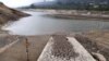 A measuring bar is exposed by the low water level in the San Rafael reservoir in La Calera, Colombia, April 8, 2024. Bogota will start rationing water this week to alleviate droughts wrought by the El Nino weather pattern.