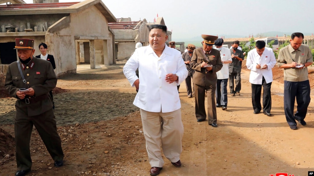 FILE - In this undated photo provided on July 23, 2020, by the North Korean government, North Korean leader Kim Jong Un visits a chicken farm being built in Hwangju County, North Korea.