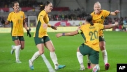 FILE - Australia's Sam Kerr, second right, celebrates with teammates after scoring against England during their women's international friendly soccer match in London, April 11, 2023.