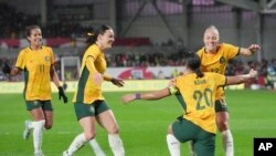 FILE - Australia's Sam Kerr, second right, celebrates with teammates after scoring against England during their women's international friendly soccer match in London, April 11, 2023.