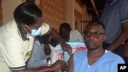 FILE - A man receives a shot of yellow fever vaccine at Kiswa Health Center III in Kampala, Uganda, April. 2, 2024.