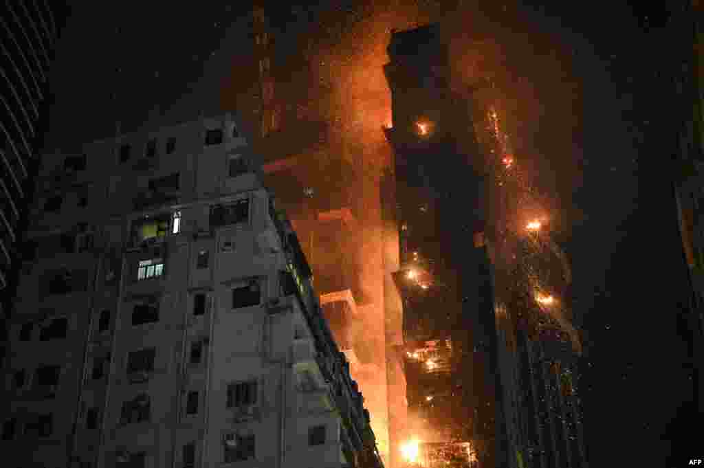 A fire burns at a high-rise building under construction in the Tsim Sha Tsui district in Hong Kong.