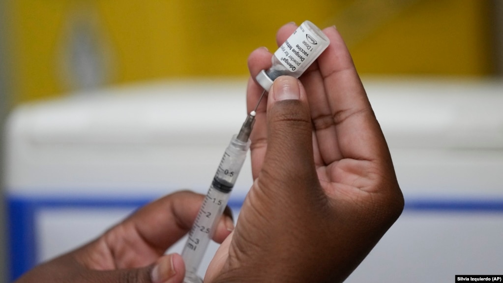 FILE - A healthcare worker prepares the Qdenga vaccine during a vaccination campaign at a health center in Rio de Janeiro, Brazil, Feb. 23, 2024. (AP Photo/Silvia Izquierdo)