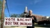 Rob Romeijn protests property taxes outside Rockdale County offices in Conyers, Ga., on April 23, 2024. Romeijn says the increase in the taxable value of his house is unfair.