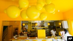 Shuggie's Trash Pie chef and co-owner David Murphy, second from left, and staff prepare food in the restaurant's kitchen in San Francisco, June 14, 2023.