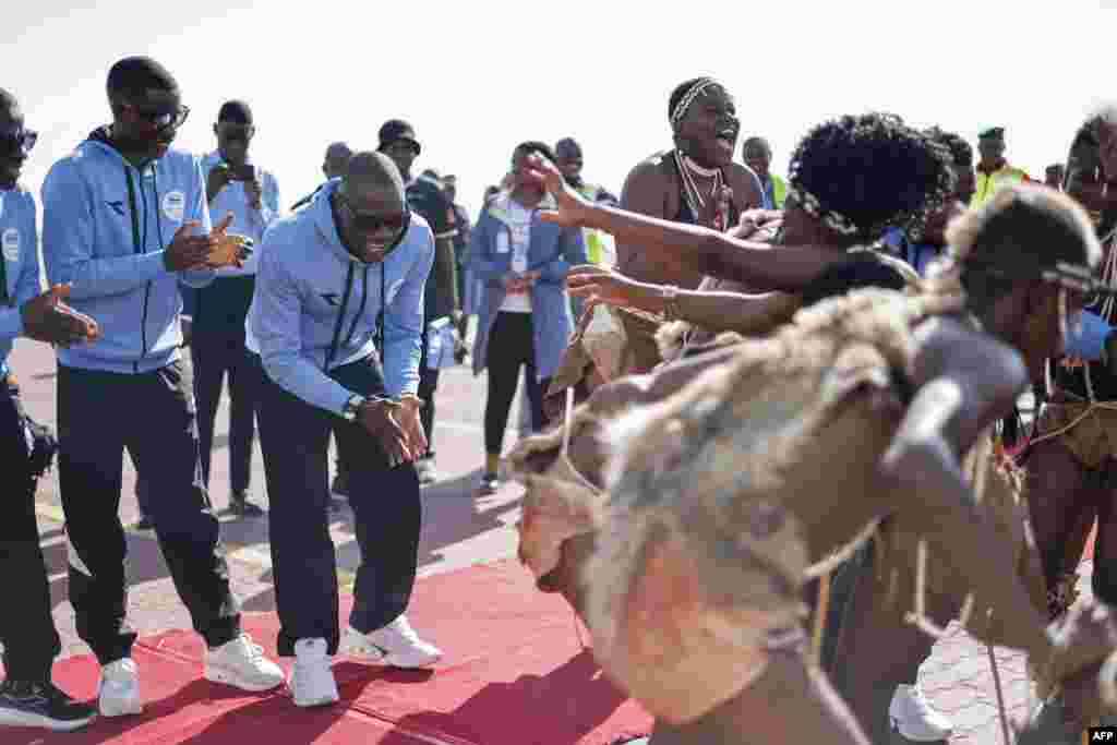 Olympic gold medalist Letsile Tebogo, 2nd left, dances with cultural dancers during a welcoming ceremony after winning the men&#39;s 200m athletics event during the Paris 2024 Olympic Games, at the Sir Seretse Khama International Airport in Gaborone.&nbsp;President Mokgweetsi Masisi declared Tuesday afternoon a holiday in honor of&nbsp;Tebogo.