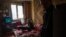 Olga says at least one room of her house wasn’t affected by the shrapnel from the bombs that fell around the building where she lives with her husband and their dog in Kharkiv, Feb. 15, 2023.
