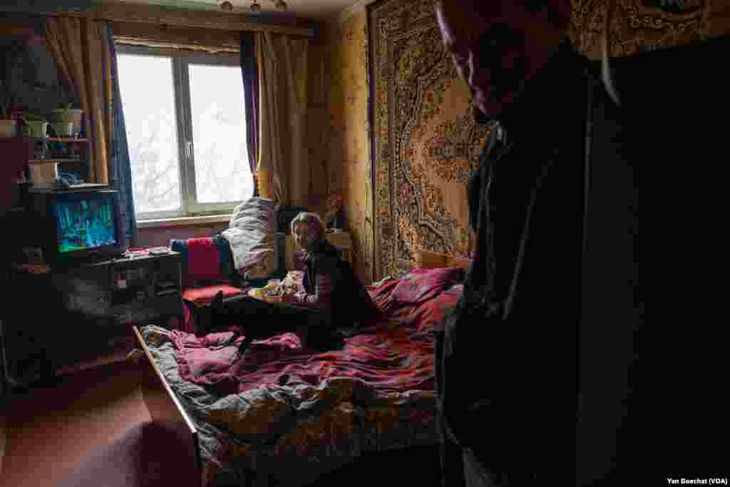 Olga says at least one room of her house wasn’t affected by the shrapnel from the bombs that fell around the building where she lives with her husband and their dog in Kharkiv, Feb. 15, 2023.