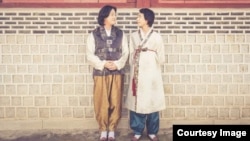 Kim Yong-min and his partner, So Seong-wook, pose in traditional Korean garments. Courtesy Kim Yong-min.