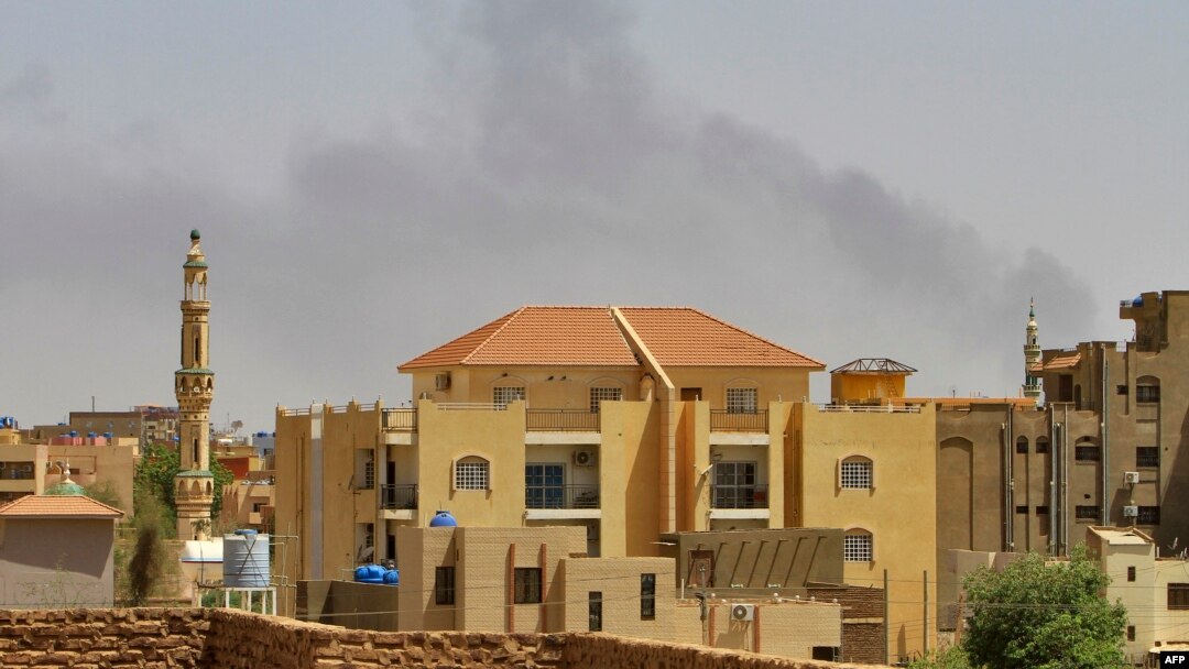 Smoke rises above buildings in Khartoum on May 12, 2023, as fighting between the forces of two rival generals continues. Warplanes roared overhead as explosions rocked the city.