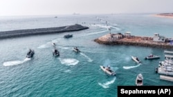 In this photo released, Aug. 2, 2023, by Sepahnews of the Iranian Revolutionary Guard, the Guard's speedboats move during a drill in the Persian Gulf.