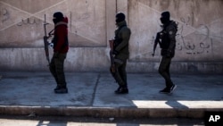 FILE - U.S. backed Syrian Democratic Forces soldiers search for Islamic State militants in Hassakeh, Syria, Jan. 28, 2022. 