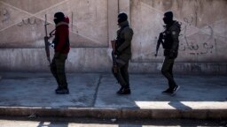 FILE - U.S. backed Syrian Democratic Forces soldiers search for Islamic State militants in Hassakeh, Syria, Jan. 28, 2022. 