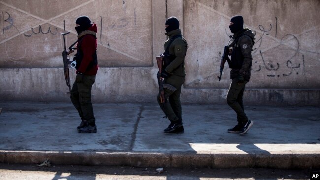 FILE - U.S. backed Syrian Democratic Forces soldiers search for Islamic State militants in Hassakeh, Syria, Jan. 28, 2022.