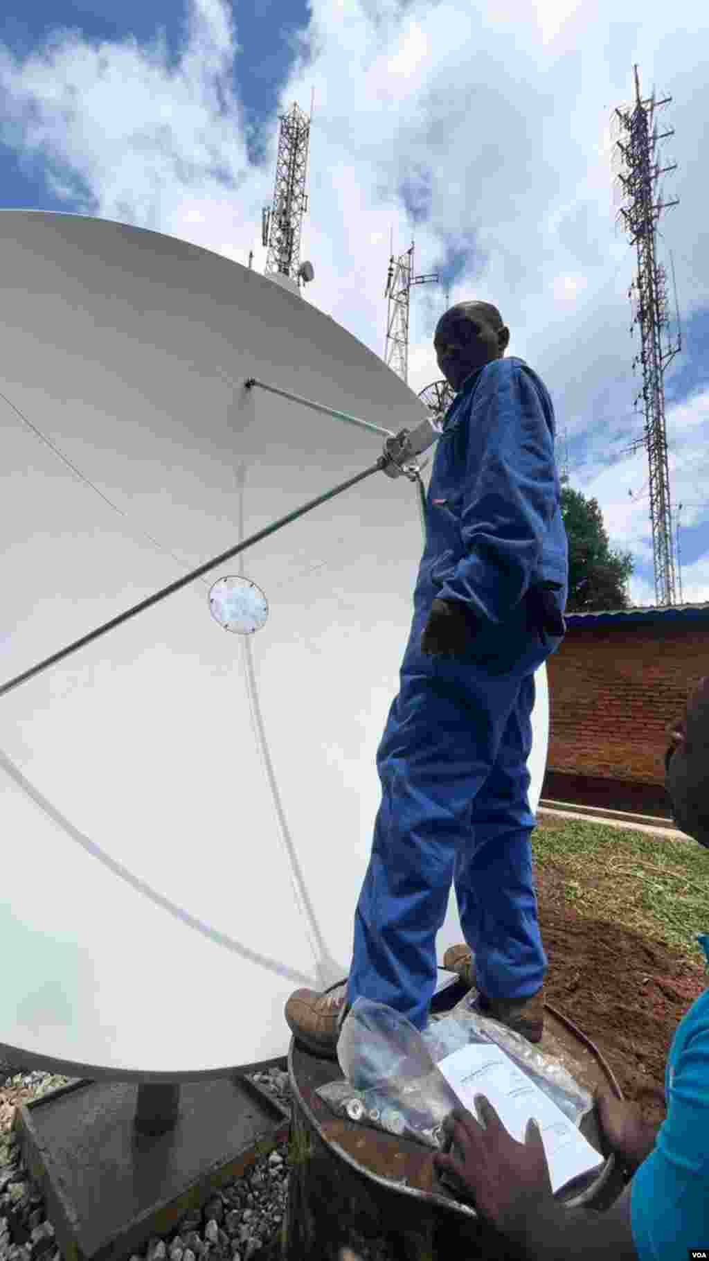 Technicians install satellite-tuning equipment at FM 93.3, the Voice of America’s new radio station serving the Karongi district of Rwanda.