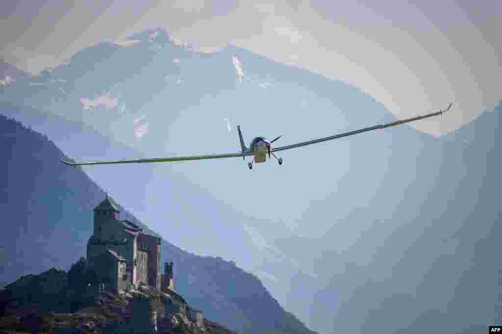 Sun-powered stratospheric SolarStratos plane flies before landing in Sion airport with the Tourbillon Castle in the background. The plane was moved to its new base in Payerne ahead of its 10,000-meter altitude world-record attempt.