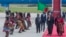 U.S. Vice President Kamala Harris, second right, is greeted by traditional dancers after landing in Lusaka, Zambia, March 31, 2023.