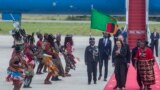 U.S. Vice President Kamala Harris, second right, is greeted by traditional dancers after landing in Lusaka, Zambia, March 31, 2023.