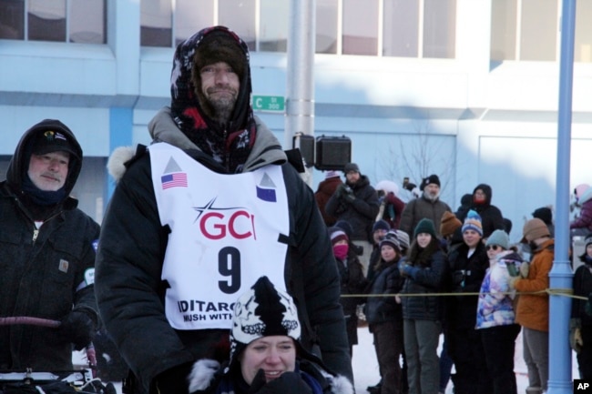 Musher Nic Petit, wearing big No. 9, makes his way down Fourth Avenue during the ceremonial start of the Iditarod Trail Sled Dog Race Saturday, March 4, 2023, in Anchorage, Alaska. (AP Photo/Mark Thiessen)