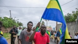 People celebrate in support of the coup leaders in a street of Port-Gentil, Gabon Aug. 30, 2023.