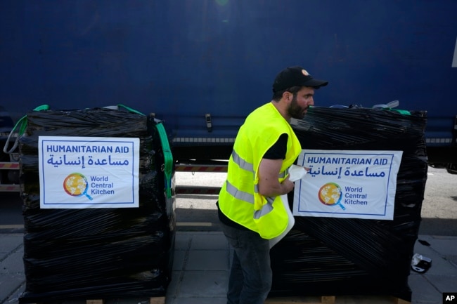 FILE - A member of the World Central Kitchen prepares a pallet with the humanitarian aid for transport to the port of Larnaca from where it will be shipped to Gaza, at a warehouse near Larnaca, Cyprus, on March 13, 2024. (AP Photo/Petros Karadjias, File)