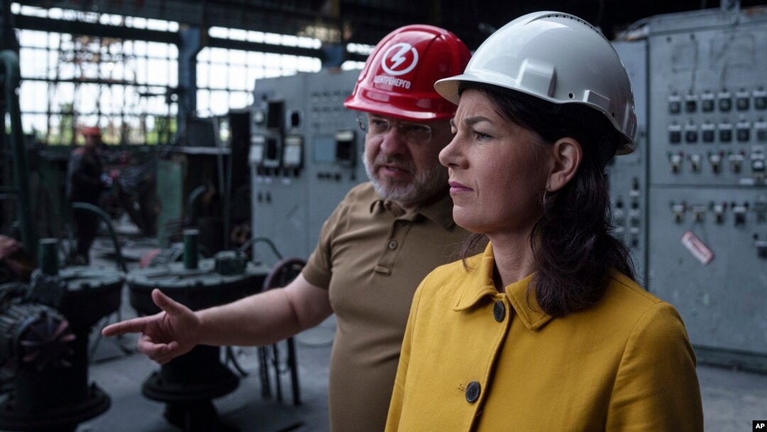 Menlu Jerman Annalena Baerbock (kanan) berbicara dengan Menteri Energi Ukraina Herman Halushchenko saat kunjungan resmi ke pembangkit listrik yang hancur akibat serangan roket Rusia di Ukraina, Selasa, 21 Mei 2024.