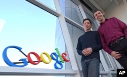 In this file photo, Google co-founders Sergey Brin, left, and Larry Page pose at company headquarters Jan.15, 2004, in Mountain View, Calif. (AP Photo/Ben Margot, File)