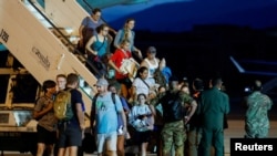 Italian nationals and other European and American citizens who evacuated Niger arrive at Ciampino Airport near Rome, Aug. 2, 2023.