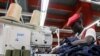 FILE - Isaac Wekesa sews a pair of denim trousers for export at the United Aryan Export Processing Zone (EPZ) factory, operating under the U.S. African Growth and Opportunity Act (AGOA), in Ruaraka district of Nairobi, Kenya on October 26, 2023. 