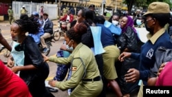 Police officers disperse female opposition lawmakers as they attempt to deliver a petition to the Ministry of Internal Affairs, in Kampala, Uganda, April 27, 2023.