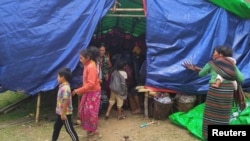 FILE - People displaced by fighting in north-western Myanmar between junta forces and anti-junta fighters are seen at a camp in Chin State, Myanmar, May 31, 2021.