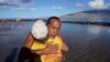 Vicente Ruboi receives a hug after performing a blessing to greeting the day Aug. 15, 2023, in Kihei, Hawaii. 