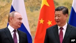 FILE - Chinese President Xi Jinping and Russian President Vladimir Putin meet in Beijing, China, on Feb. 4, 2022.