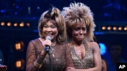 Singer Tina Turner, left, speaks on stage with actress Adrienne Warren on the opening night of "Tina – The Tina Turner Musical" at the Lunt-Fontanne Theatre, Nov. 7, 2019, in New York.