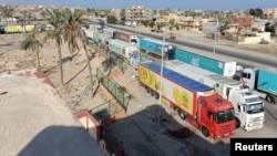 A view of trucks carrying humanitarian aid for Palestinians, as they wait for the re-opening of the Rafah border crossing to enter Gaza, in the city of Al-Arish, Egypt, October 16, 2023. (REUTERS/Stringer)