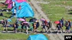 Scouts leave the campsite of the World Scout Jamboree in Buan, North Jeolla province, South Korea. Organisers of the World Scout Jamboree asked host South Korea to "urgently" evacuate tens of thousands of children from their campsite ahead of a typhoon, just days after a heatwave caused mass scout illnesses.