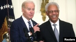 FILE: U.S. President Joe Biden pulls Norm Griffiths onto the stage while delivering remarks during a reception celebrating Black History Month in the East Room at the White House in Washington. Taken Feb. 27, 2023