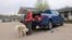 Wildfire evacuee Colin Guilder and his dog, Sheba, are pictured at a gas station and motel in northern Alberta the day after a wildfire caused the evacuation of communities on the southern edge of Fort McMurray, May 15, 2024.