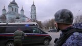 A vehicle carrying Wall Street Journal reporter Evan Gershkovich, detained on suspicion of espionage, drives away from a court building in Moscow, Russia March 30, 2023.