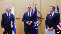 NATO Secretary General Jens Stoltenberg, center, speaks after Finnish Foreign Minister Pekka Haavisto, left, handed over his nation's accession documents to U.S. Secretary of State Antony Blinken at NATO headquarters in Brussels, April 4, 2023.