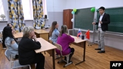 ChineseFirst language center co-founder Wang Yinyu teaches a Chinese class for adults, in the town of Reutov, outside Moscow, Russia, March 17, 2023.