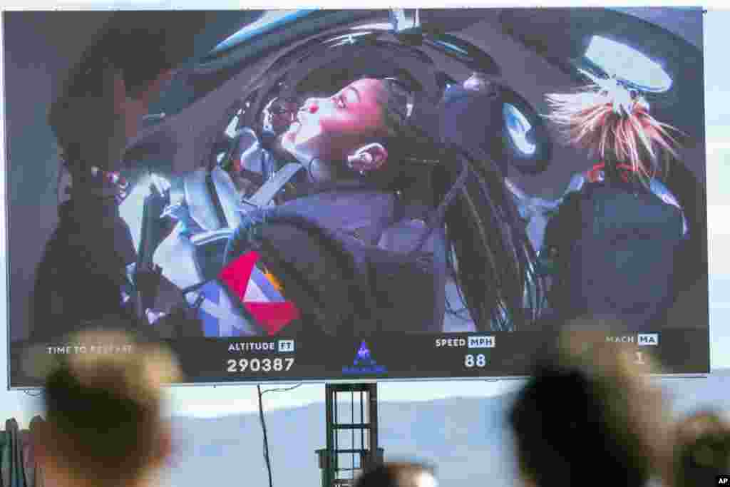 Guests watch a live broadcast from inside Virgin Galactic&#39;s rocket-powered plane Unity 22, showing space tourists Anastatia Mayers, 18, and her mother Keisha Schahaff, rear, at Spaceport America, near Truth or Consequences, New Mexico.&nbsp;