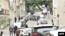 Police set up a cordon around the Iranian consulate in Paris after reports of a person entering the building with an explosive device. (Screenshot from AFP video)