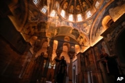 A visitor takes photographs during her visit to a former Byzantine church which formally opened as a mosque, in Istanbul, Turkey, May 6, 2024.