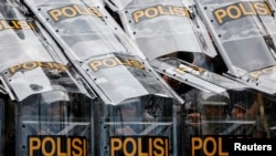 Riot police guard during a protest against controversial revisions to election law outside the Indonesian Parliament building in Jakarta on Aug. 22, 2024.