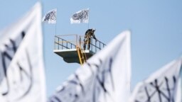 FILE - A Taliban fighter is seen at the Taliban flag-raising ceremony in Kabul, Afghanistan, March 31, 2022. 
