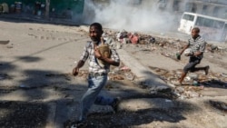 Hombres corren a refugiarse mientras la policía antidisturbios lanza gases lacrimógenos en un esfuerzo por dispersar a la gente cerca del Palacio Nacional, en Puerto Príncipe, Haití, el martes 2 de abril de 2024.[Foto: Archivo/AP].